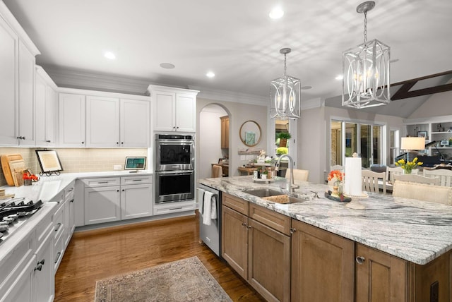 800 Singleton Ln, Brentwood, TN 37027 - kitchen with appliances with stainless steel finishes, a chandelier, white cabinets, recessed lighting, and arched walkways