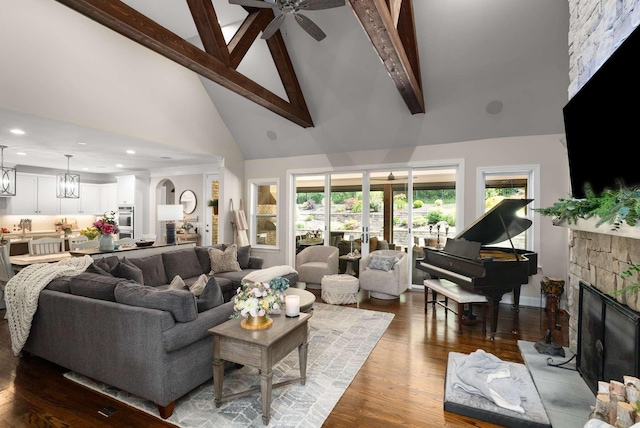 800 Singleton Ln, Brentwood, TN 37027 - living room with high vaulted ceiling, beamed ceiling, a stone fireplace, ceiling fan, and wood finished floors