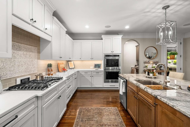800 Singleton Ln, Brentwood, TN 37027 - kitchen featuring stainless steel appliances, arched walkways, white cabinetry, ornamental molding, and recessed lighting