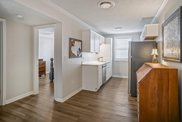 1301 Neelys Bend Rd Unit 14, Madison, TN 37115 - kitchen with a textured ceiling, light countertops, appliances with stainless steel finishes, dark wood-type flooring, and white cabinets