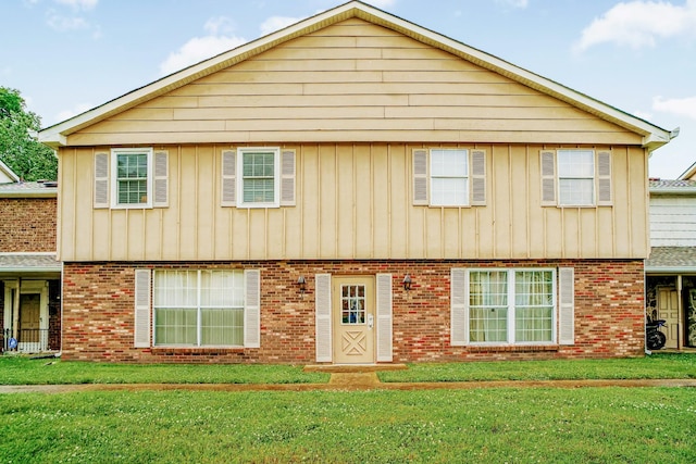 1301 Neelys Bend Rd Unit 14, Madison, TN 37115 - colonial-style house with a front yard, board and batten siding, and brick siding