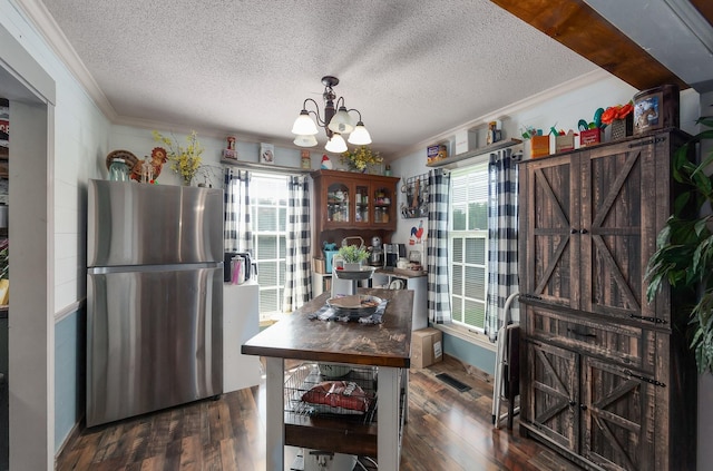 10 Clinton Rd, Humboldt, TN 38343 - dining area with ornamental molding, a textured ceiling, a chandelier, plenty of natural light, and wood finished floors