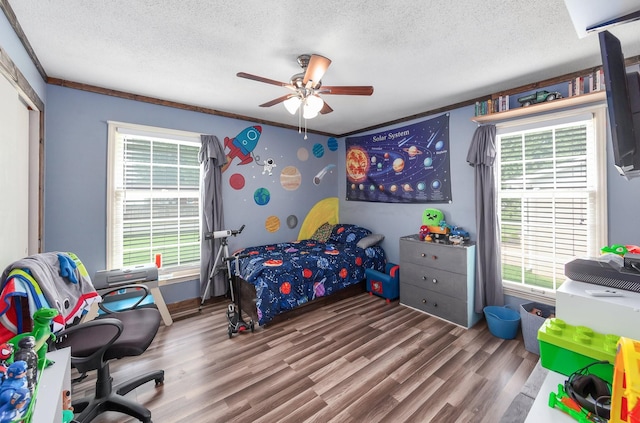 10 Clinton Rd, Humboldt, TN 38343 - bedroom featuring a textured ceiling, wood finished floors, multiple windows, a ceiling fan, and a closet