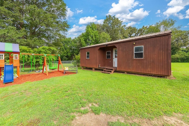 10 Clinton Rd, Humboldt, TN 38343 - rear view of property featuring a playground, a metal roof, and view of wooded area