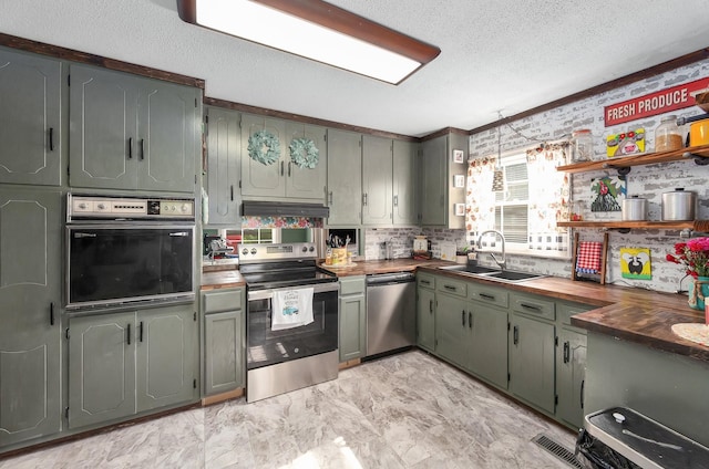 10 Clinton Rd, Humboldt, TN 38343 - kitchen with stainless steel appliances, wooden counters, open shelves, a textured ceiling, and light marble finish floors