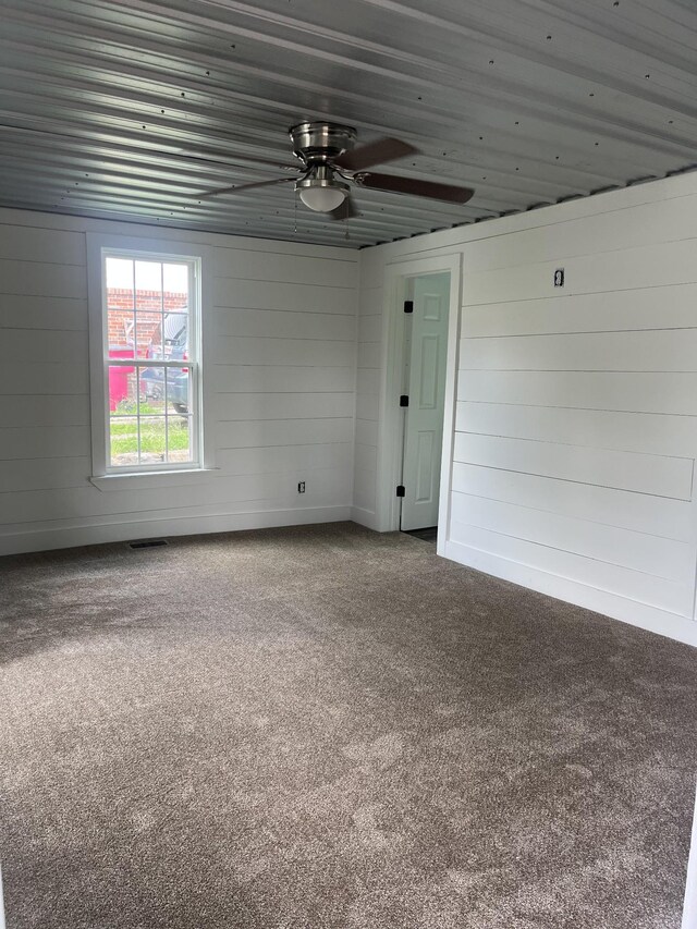 218 Ward Ave E, Carthage, TN 37030 - carpeted empty room with ceiling fan and wooden walls