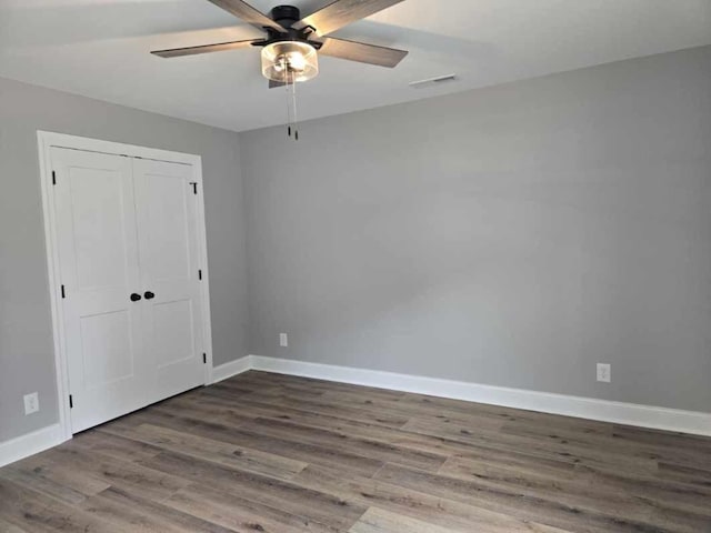 504 1st St, Lawrenceburg, TN 38464 - unfurnished bedroom featuring wood finished floors, a closet, and ceiling fan