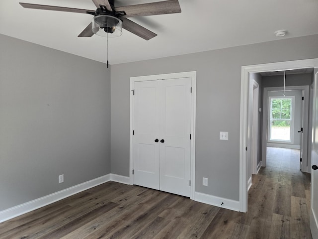 504 1st St, Lawrenceburg, TN 38464 - unfurnished bedroom with attic access, dark wood-style flooring, a closet, and a ceiling fan
