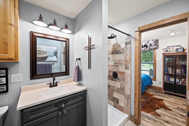 634 Cowboy Way, Jamestown, TN 38556 - ensuite bathroom featuring wood finished floors, vanity, and a tile shower