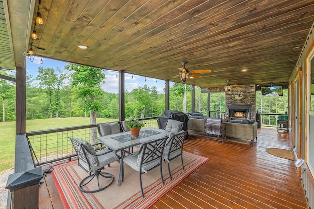 634 Cowboy Way, Jamestown, TN 38556 - wooden deck featuring outdoor dining area, an outdoor living space with a fireplace, a lawn, and a grill