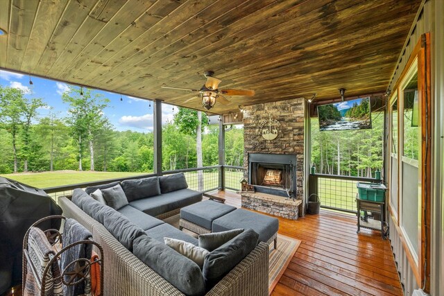 634 Cowboy Way, Jamestown, TN 38556 - sunroom / solarium with ceiling fan, an outdoor living space with a fireplace, and healthy amount of natural light