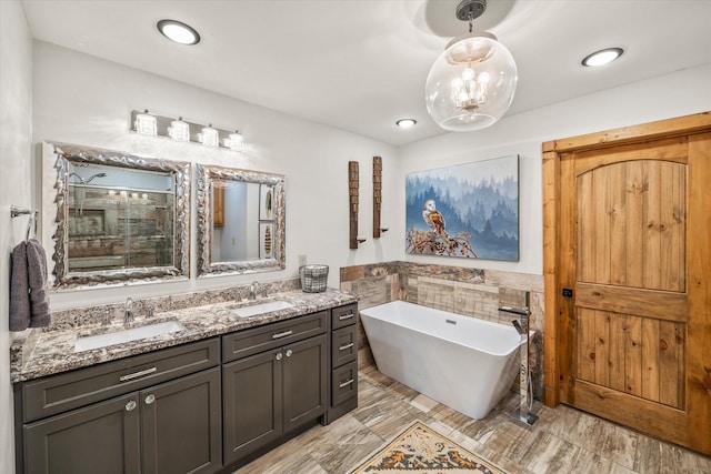 634 Cowboy Way, Jamestown, TN 38556 - full bath featuring tile walls, a soaking tub, double vanity, a shower stall, and a wainscoted wall