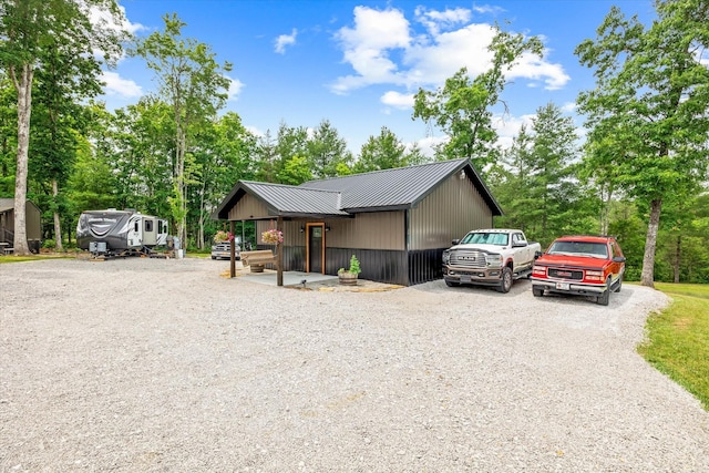 634 Cowboy Way, Jamestown, TN 38556 - view of front of house featuring driveway, a metal roof, and view of scattered trees