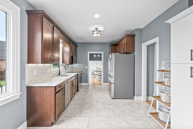 4921 Sango Rd, Clarksville, TN 37043 - kitchen featuring stainless steel appliances, backsplash, and light stone countertops