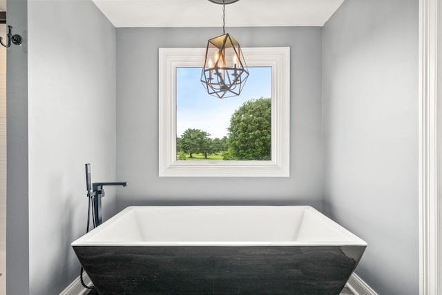 4921 Sango Rd, Clarksville, TN 37043 - full bathroom featuring a soaking tub and a chandelier