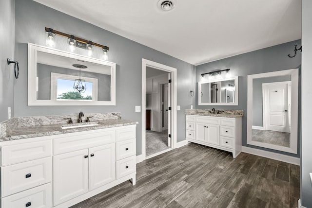 4921 Sango Rd, Clarksville, TN 37043 - full bathroom featuring wood finished floors and two vanities