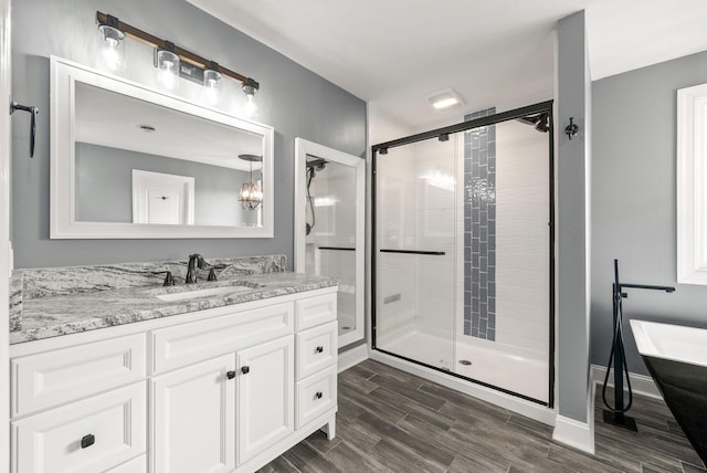 4921 Sango Rd, Clarksville, TN 37043 - bathroom with a freestanding bath, a stall shower, vanity, and wood finished floors