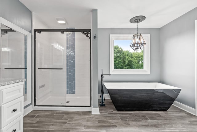 4921 Sango Rd, Clarksville, TN 37043 - bathroom featuring a soaking tub, a stall shower, and wood tiled floors
