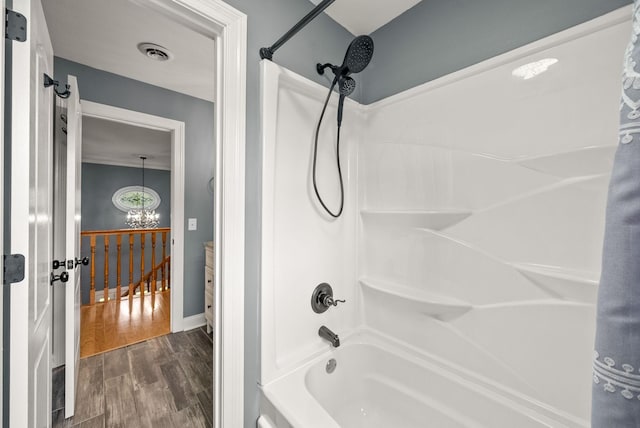 4921 Sango Rd, Clarksville, TN 37043 - bathroom featuring shower / bathtub combination with curtain, wood finished floors, and a chandelier