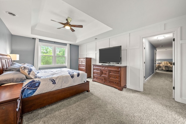 4921 Sango Rd, Clarksville, TN 37043 - bedroom featuring a raised ceiling, light colored carpet, ceiling fan, and a decorative wall