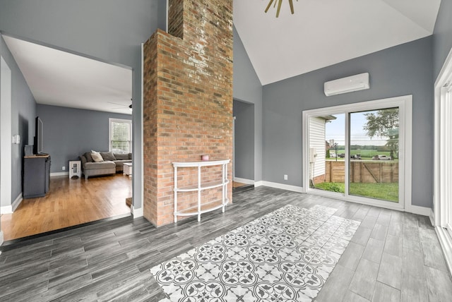 4921 Sango Rd, Clarksville, TN 37043 - living area featuring a wall mounted AC, a ceiling fan, high vaulted ceiling, and wood finished floors