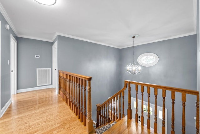 4921 Sango Rd, Clarksville, TN 37043 - corridor with an upstairs landing, a chandelier, wood finished floors, and ornamental molding