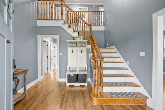 4921 Sango Rd, Clarksville, TN 37043 - staircase featuring wood finished floors, a high ceiling, and crown molding