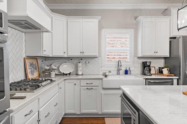 730 Fontwell Ln, Franklin, TN 37064 - kitchen featuring appliances with stainless steel finishes, custom exhaust hood, white cabinets, crown molding, and tasteful backsplash