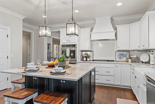 730 Fontwell Ln, Franklin, TN 37064 - kitchen featuring custom range hood, stainless steel appliances, dark wood-style flooring, white cabinetry, and crown molding