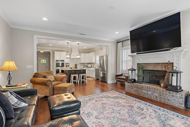730 Fontwell Ln, Franklin, TN 37064 - living area with dark wood-type flooring, ornamental molding, a fireplace, and recessed lighting