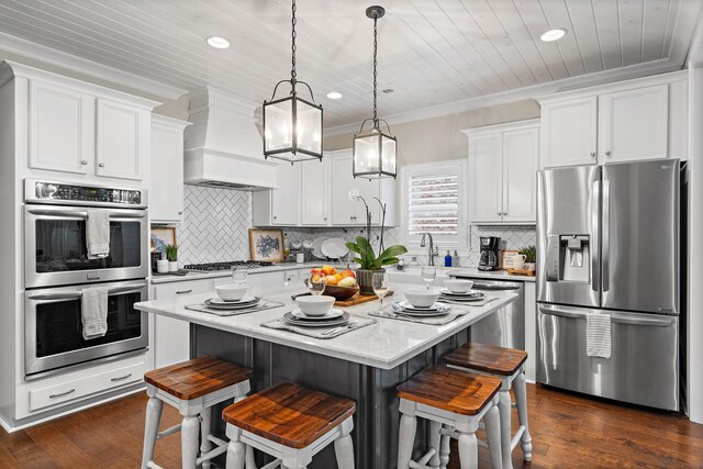 730 Fontwell Ln, Franklin, TN 37064 - kitchen with stainless steel appliances, a breakfast bar, wooden ceiling, a center island, and dark wood finished floors