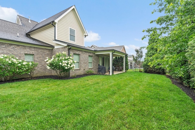 730 Fontwell Ln, Franklin, TN 37064 - back of house with a lawn, brick siding, a patio, and a shingled roof