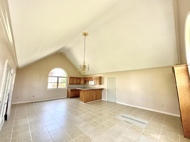 1759 Ardmore Hwy, Taft, TN 38488 - kitchen featuring open floor plan, light tile patterned floors, brown cabinetry, lofted ceiling, and a chandelier