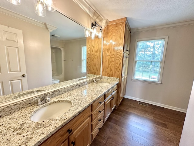 1759 Ardmore Hwy, Taft, TN 38488 - bathroom featuring wood finished floors, double vanity, crown molding, and a textured ceiling