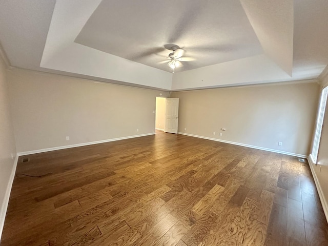 1759 Ardmore Hwy, Taft, TN 38488 - spare room featuring a raised ceiling, a ceiling fan, and dark wood-style floors