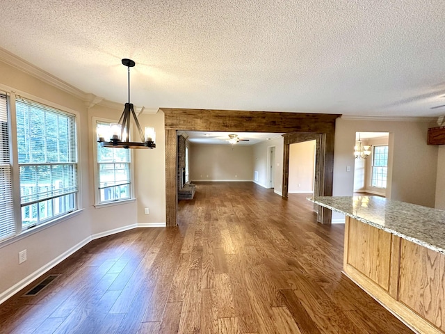 1759 Ardmore Hwy, Taft, TN 38488 - unfurnished dining area with a chandelier, a textured ceiling, ornamental molding, dark wood finished floors, and a ceiling fan