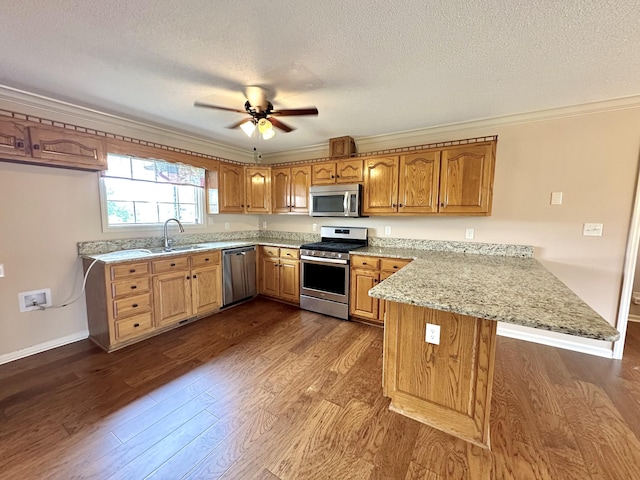 1759 Ardmore Hwy, Taft, TN 38488 - kitchen featuring stainless steel appliances, a peninsula, crown molding, dark wood-style flooring, and brown cabinetry