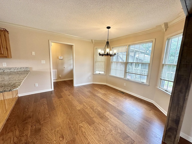1759 Ardmore Hwy, Taft, TN 38488 - unfurnished dining area featuring a textured ceiling, dark wood-style flooring, crown molding, and a chandelier