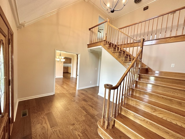 1759 Ardmore Hwy, Taft, TN 38488 - stairs featuring a chandelier, ornamental molding, vaulted ceiling, and wood finished floors