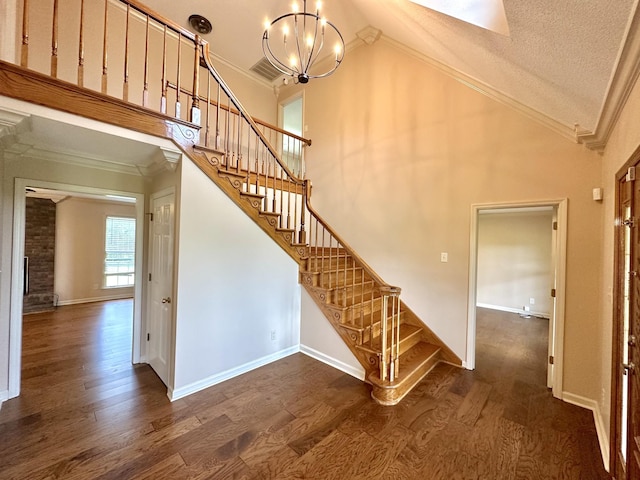 1759 Ardmore Hwy, Taft, TN 38488 - staircase featuring crown molding, wood finished floors, a chandelier, high vaulted ceiling, and a textured ceiling