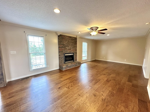 1759 Ardmore Hwy, Taft, TN 38488 - unfurnished living room featuring ornamental molding, a textured ceiling, plenty of natural light, ceiling fan, and wood finished floors