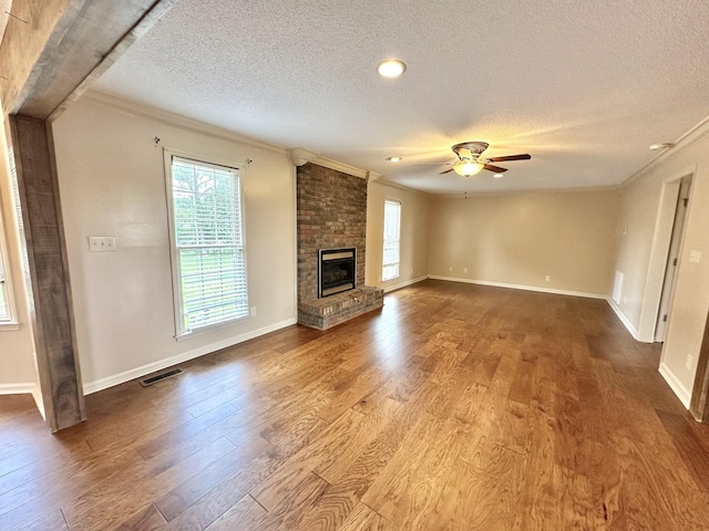 1759 Ardmore Hwy, Taft, TN 38488 - unfurnished living room with a textured ceiling, ornamental molding, healthy amount of natural light, a ceiling fan, and wood finished floors