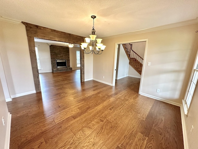1759 Ardmore Hwy, Taft, TN 38488 - unfurnished dining area with wood finished floors, a chandelier, a textured ceiling, stairway, and ornamental molding