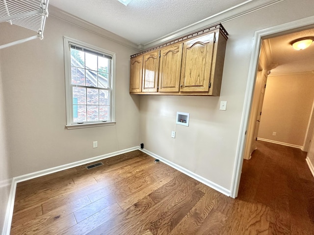 1759 Ardmore Hwy, Taft, TN 38488 - laundry room with washer hookup, crown molding, dark wood finished floors, cabinet space, and a textured ceiling