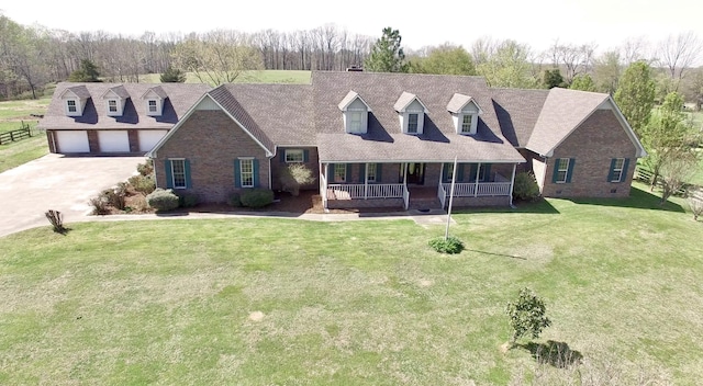1759 Ardmore Hwy, Taft, TN 38488 - new england style home featuring covered porch, brick siding, a front yard, and a garage
