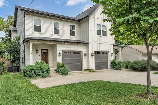 2604 Neldia Ct Unit A, Nashville, TN 37206 - view of front facade with board and batten siding, an attached garage, driveway, and a front lawn