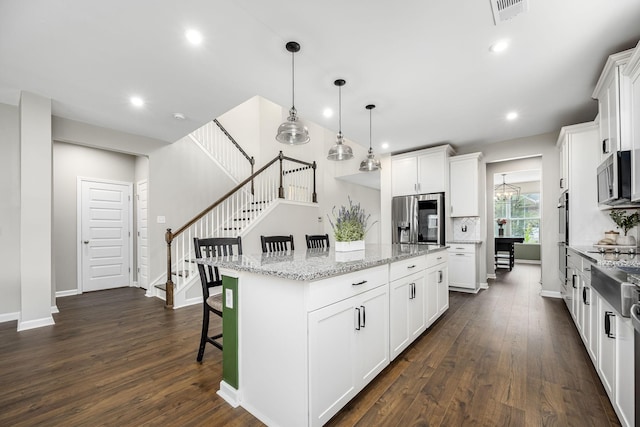 810 Corlew St, Murfreesboro, TN 37130 - kitchen featuring stainless steel appliances, a center island, dark wood finished floors, white cabinetry, and recessed lighting