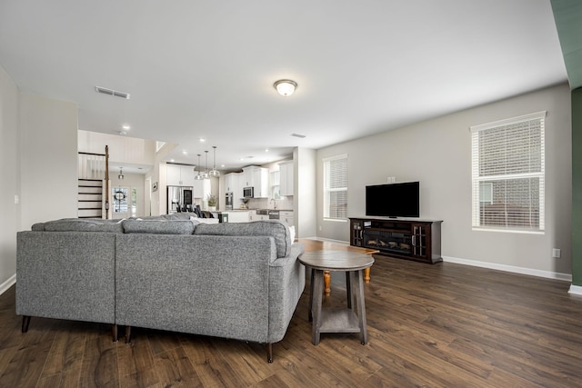 810 Corlew St, Murfreesboro, TN 37130 - living area featuring dark wood-style floors and stairs
