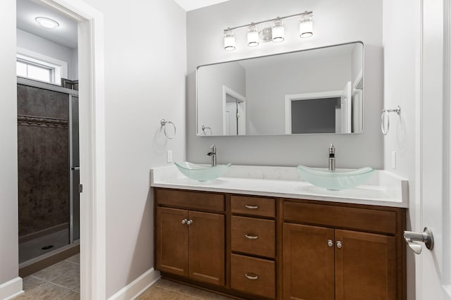 307 Seven Springs Way Unit 103, Brentwood, TN 37027 - bathroom featuring double vanity, a shower stall, and tile patterned flooring