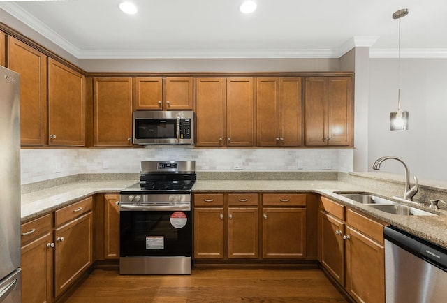 307 Seven Springs Way Unit 103, Brentwood, TN 37027 - kitchen with stainless steel appliances, ornamental molding, light stone countertops, brown cabinetry, and dark wood-style floors